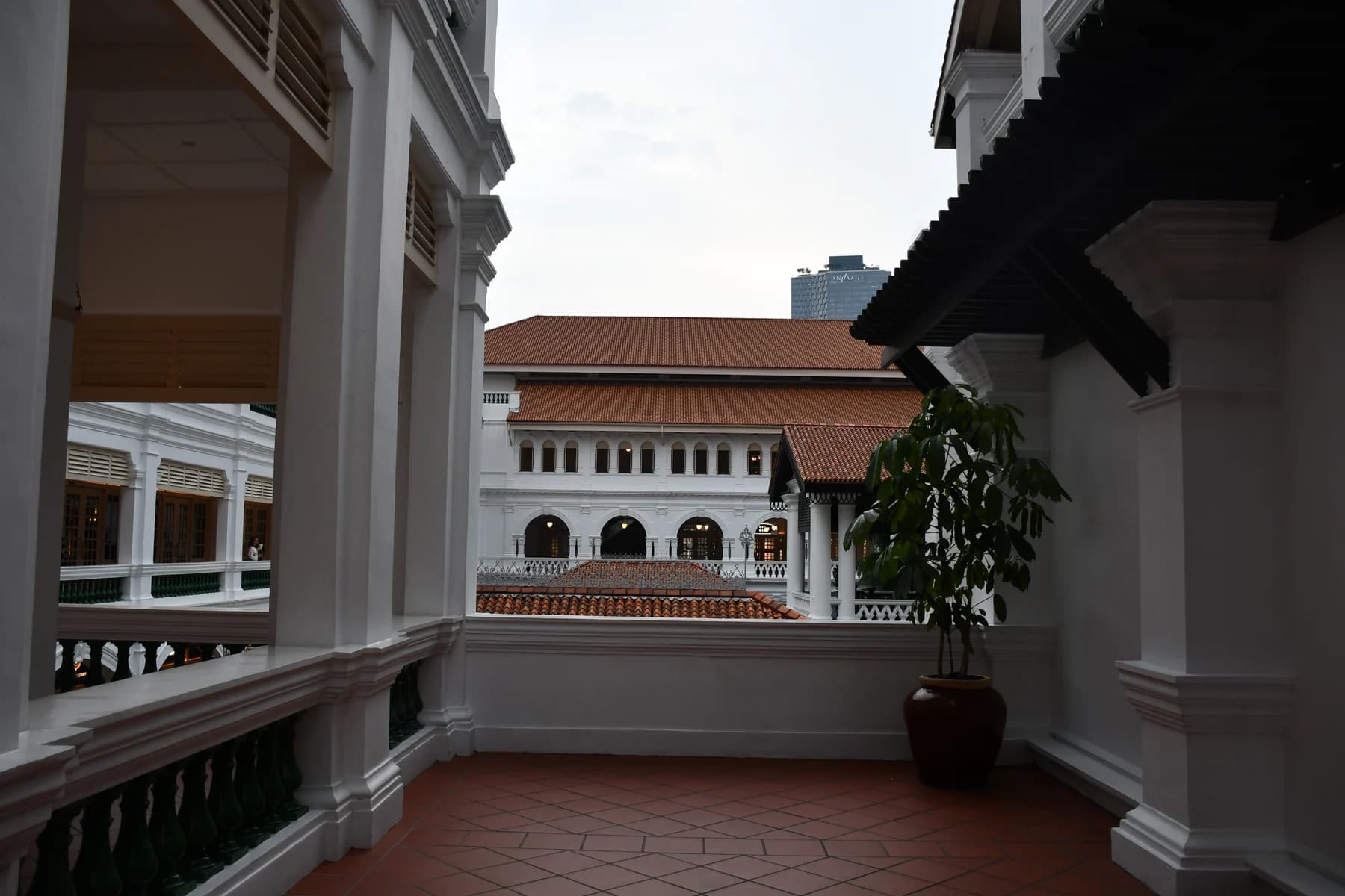 White verandas and tiled roofs around the courtyard at Raffles Singapore