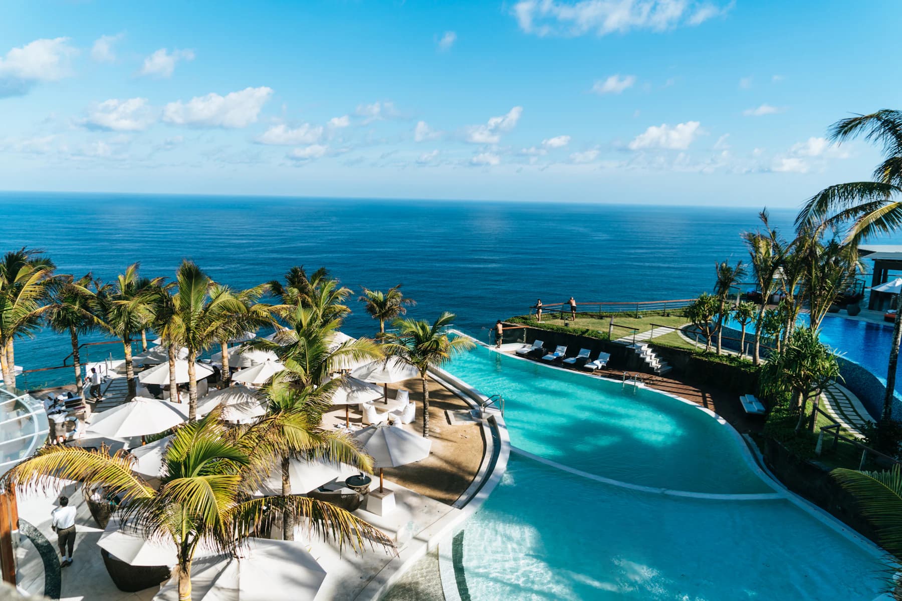 Resort swimming pool beside a blue ocean