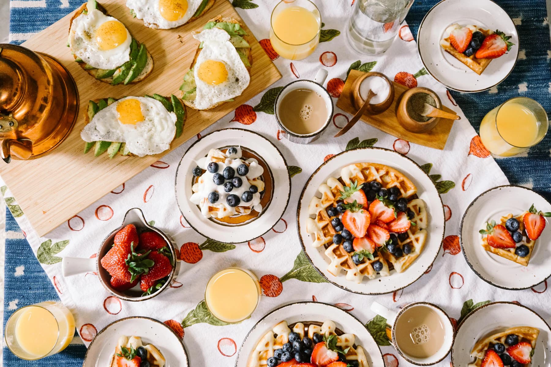 Breakfast table with waffles, eggs and juice