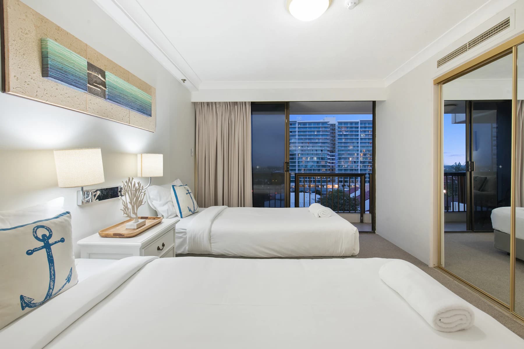 Bright apartment bedroom with white bed linen