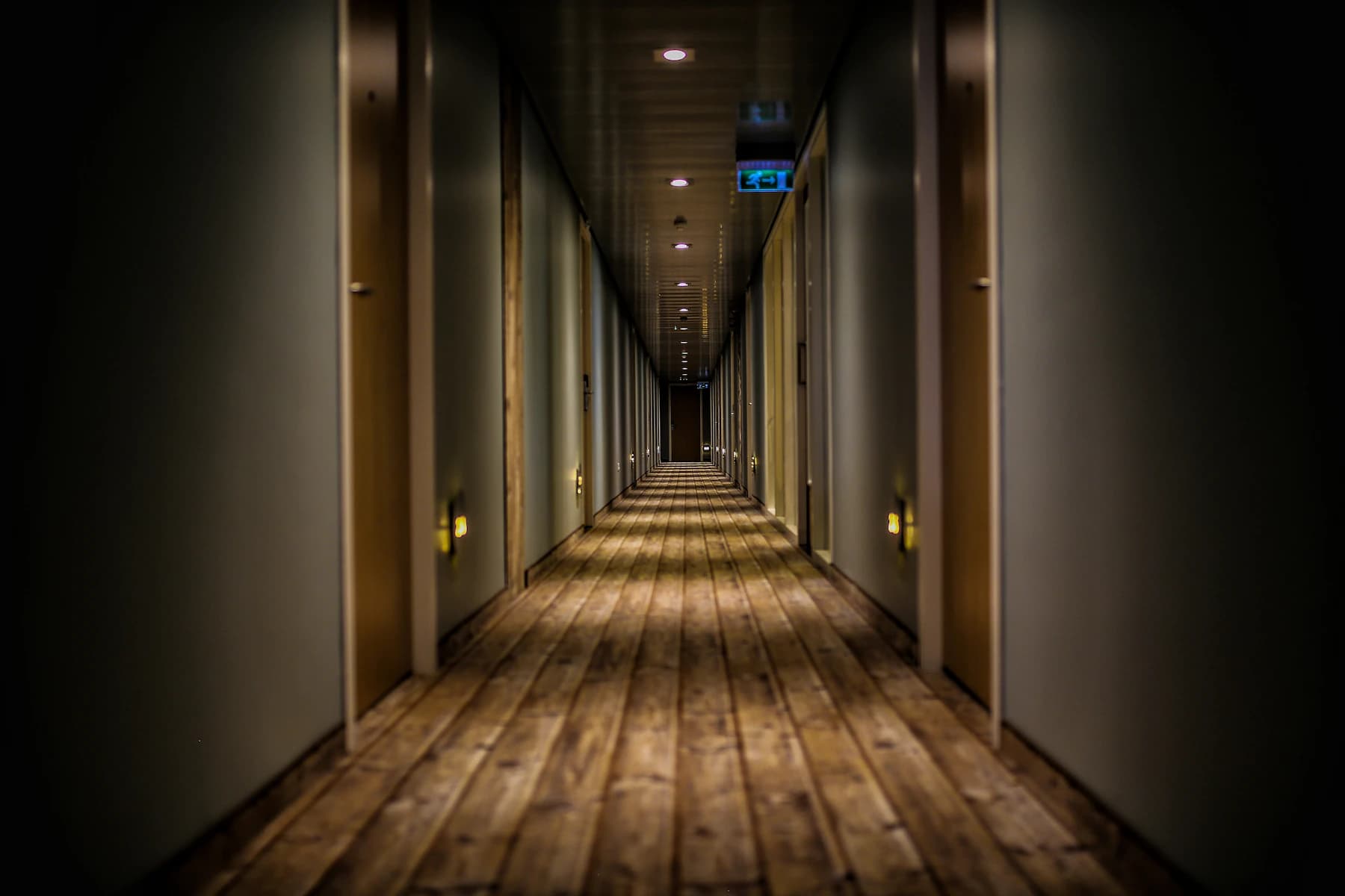 Quiet contemporary hotel corridor with warm lighting
